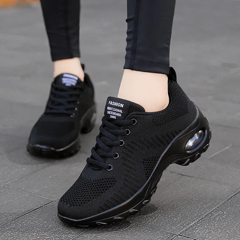 Women's red mesh sneakers with round toe and front lace-up design on flat surface