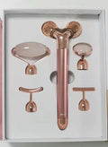 Rose gold five-in-one vibrating face lifting machine with four interchangeable jade and beauty heads in a compact box