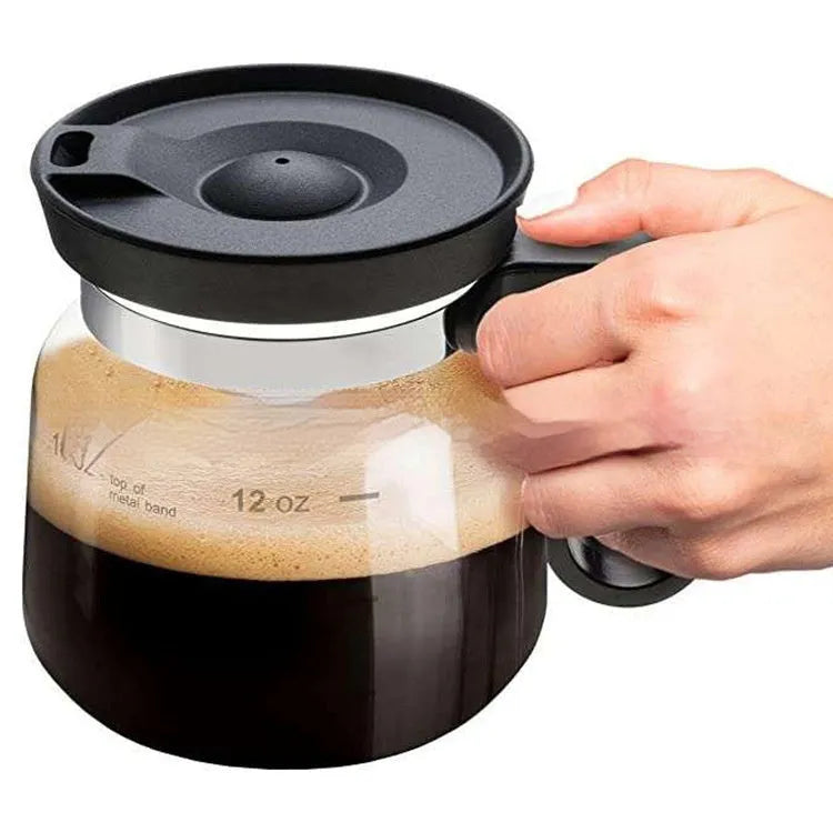 Transparent borosilicate glass coffee maker with a black silicone cover on its neck.