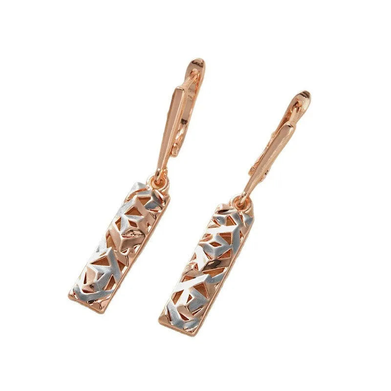 A pair of geometric hollow two-tone stud earrings with a rectangular shape and electroplated alloy finish.