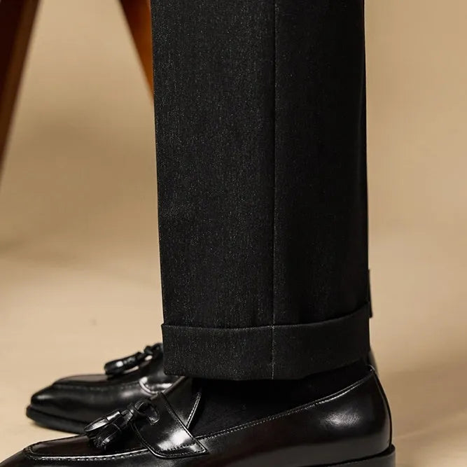 Men's leather tassel loafers in black and brown with polished finish and rubber soles
