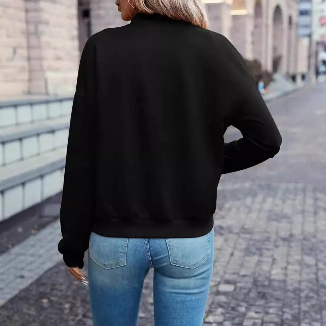 Black women's zip-front casual jacket with long sleeves on a hanger.