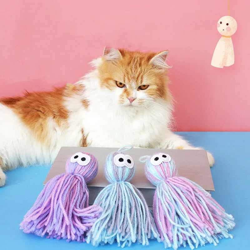 Wool ball cat toy with hanging loop in blue grey, pink and blue, and pink purple colour options