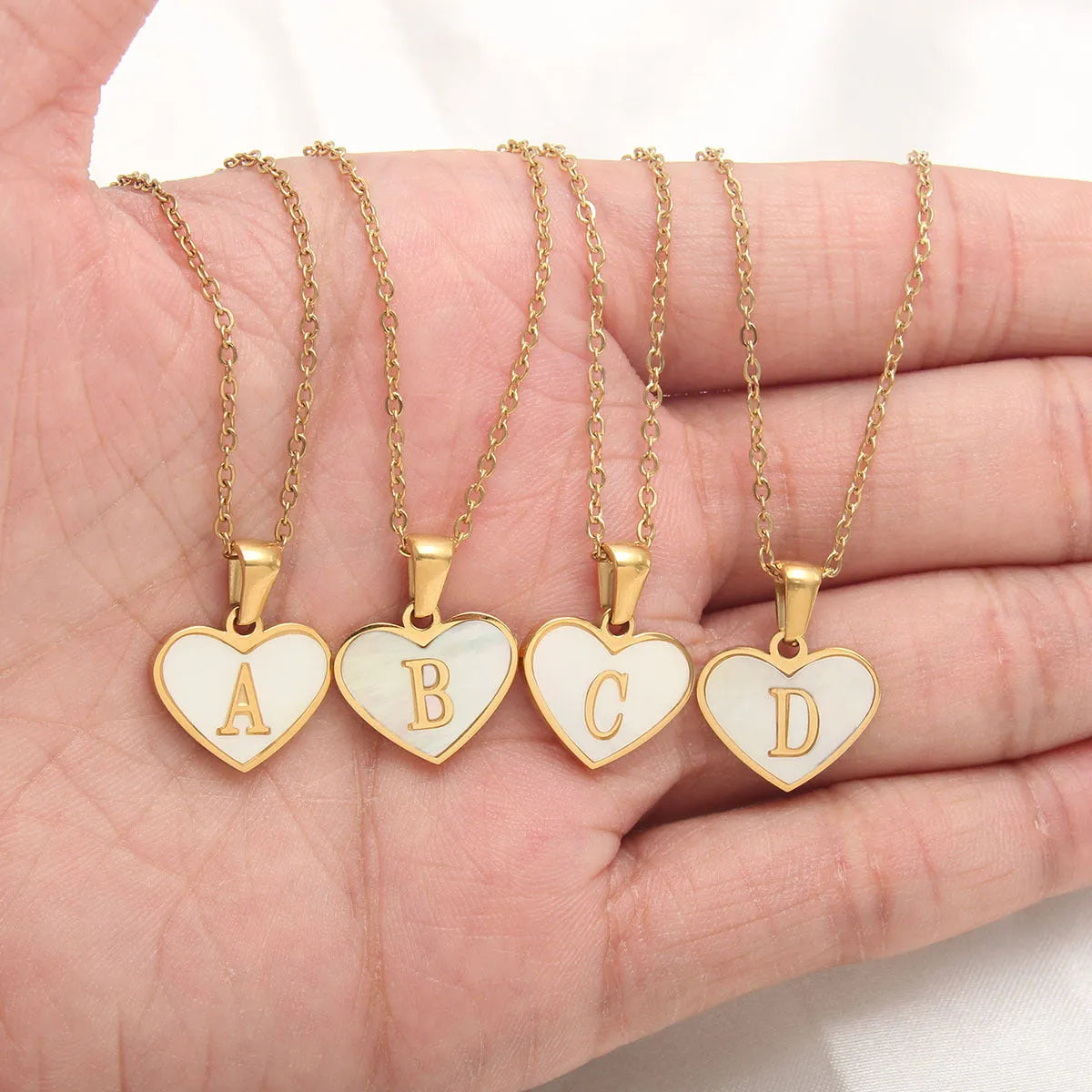 Gold plated heart pendant necklace with white shell centre and personalised letter engraving on adjustable chain