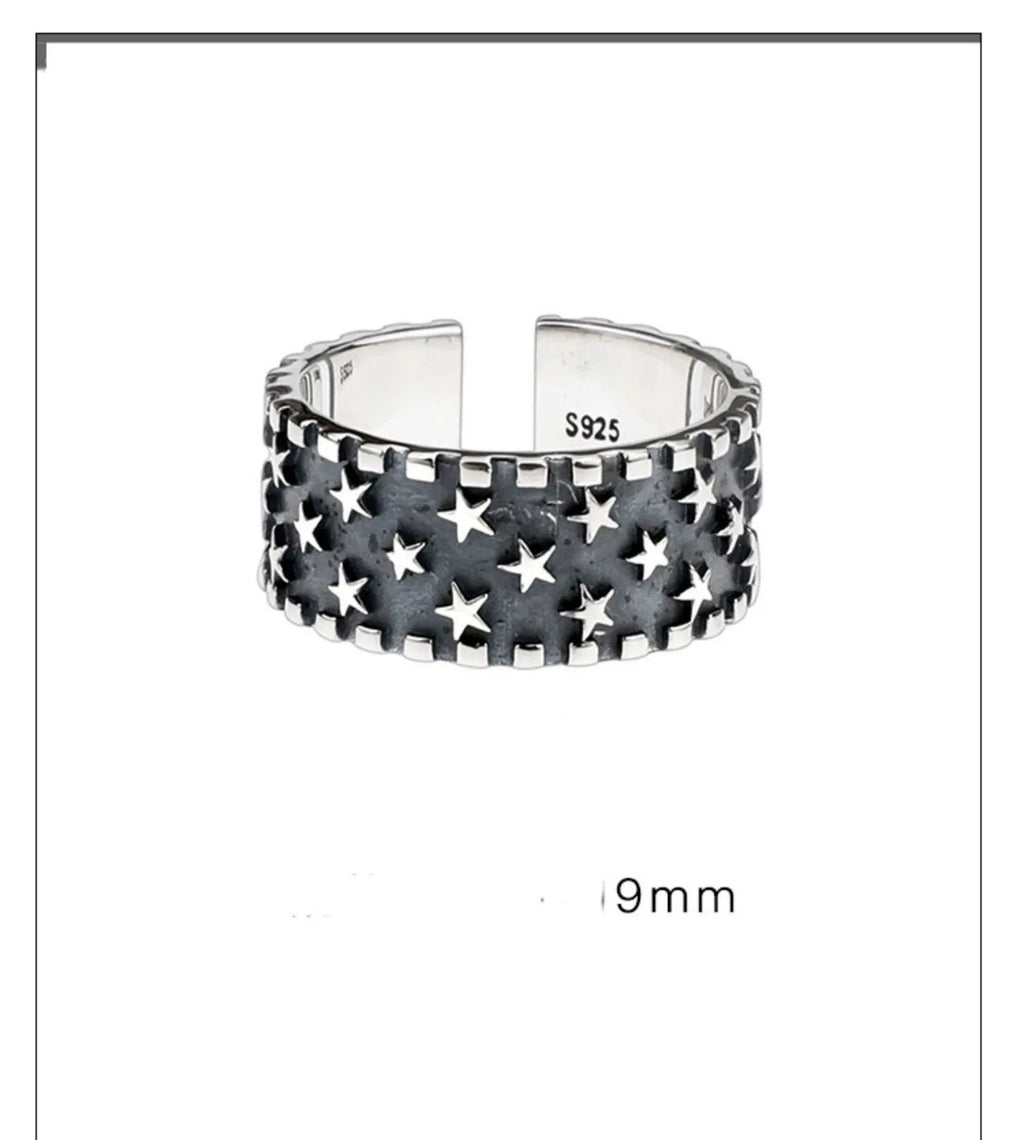 Adjustable open-ended sterling silver ring with a multi five-pointed star geometric pattern.