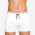 Men's solid colour polyester swimming shorts with mesh lining shown in multiple colours