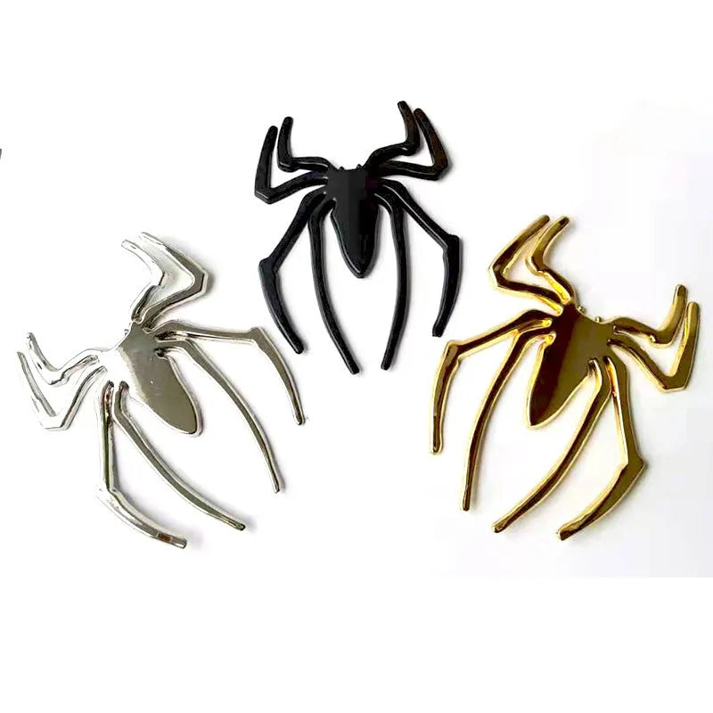 Three-dimensional metal spider car bumper sticker in zinc alloy, shown in gold colour.