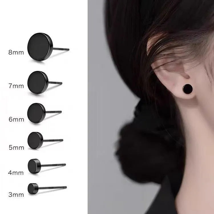 A pair of simple round flat-front sterling silver S999 ear bone stud earrings on a plain background.
