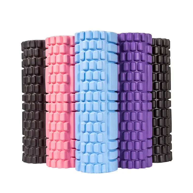 EVA foam fitness roller in black on a wooden floor, showing cylindrical shape and textured surface.