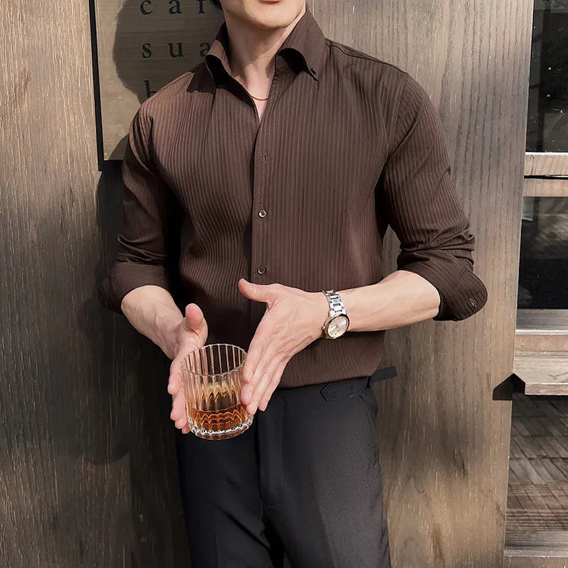Man wearing a dark striped long sleeve V-neck cardigan shirt in a casual setting.