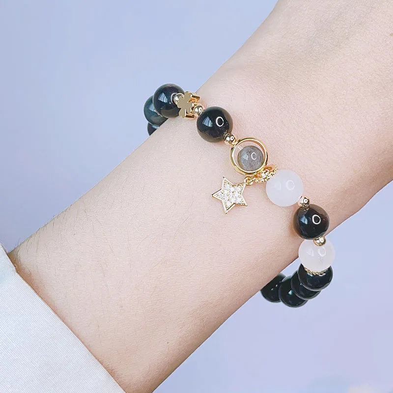 Silver stone bracelet with electroplated finish showing floral, love heart, and star charm designs