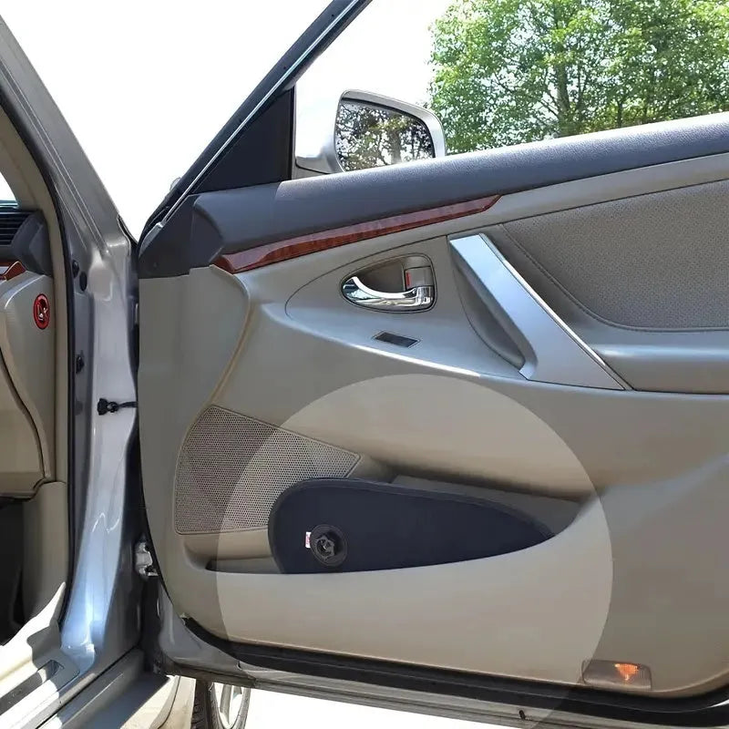 Black stretchy car side window sun shade attached with suction cups, showing adjustable coverage.