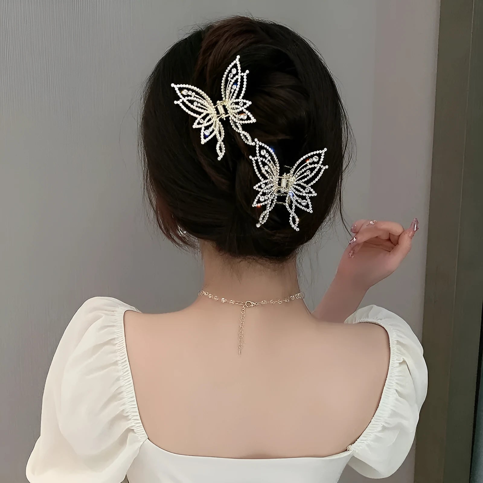 Butterfly-shaped hair barrettes for women with alloy construction and decorative rhinestone or pearl styling