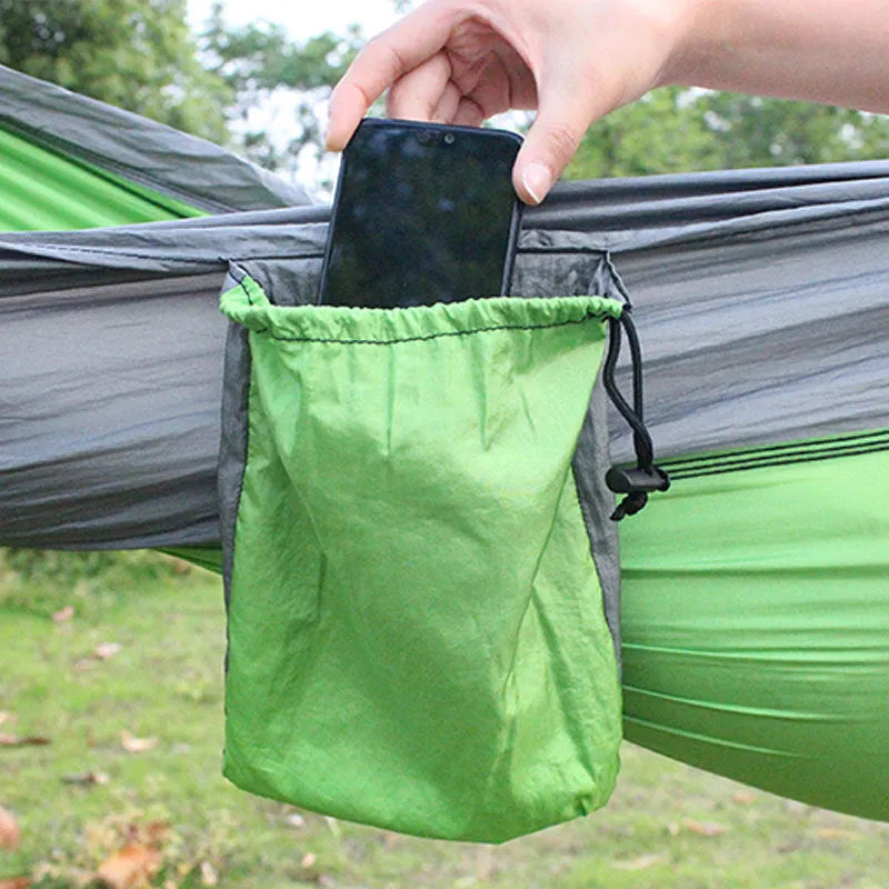 Blue and grey parachute nylon outdoor hammock hung between trees, showing its spacious 270cm length.