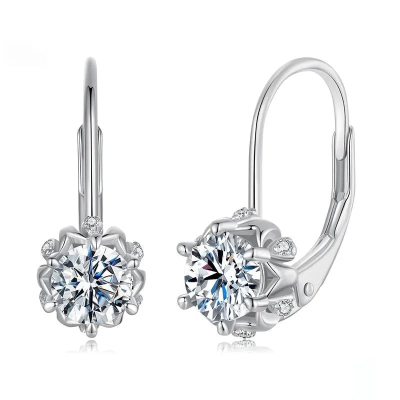 Sterling silver flower bud shaped ear clips with a white gold plated finish and a central moissanite stone.