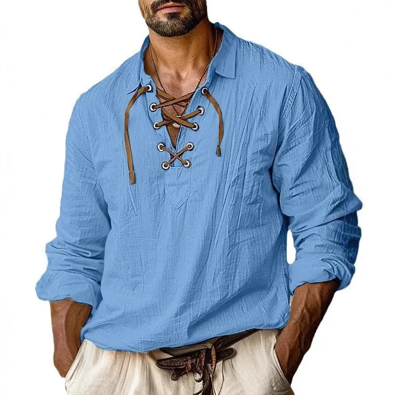 Man wearing a solid blue loose-fit linen blend shirt with lapels and lace detailing on the front.