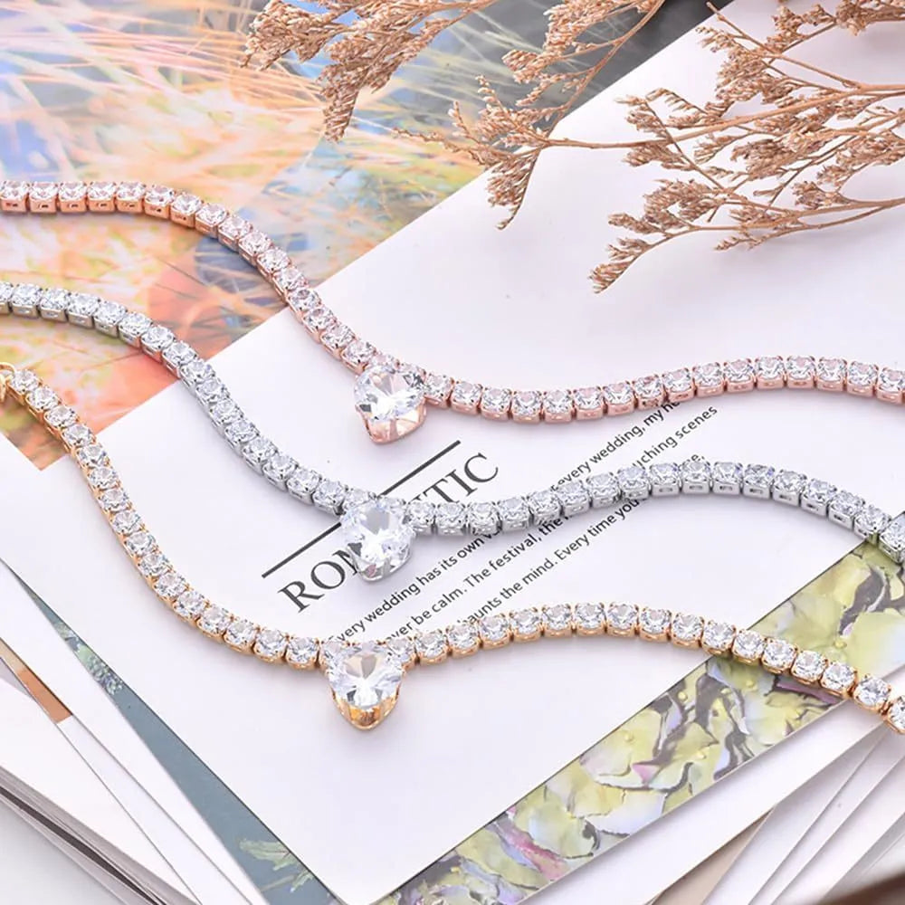Gold rhinestone heart-shaped decorative collar for dogs or cats on a metal chain.