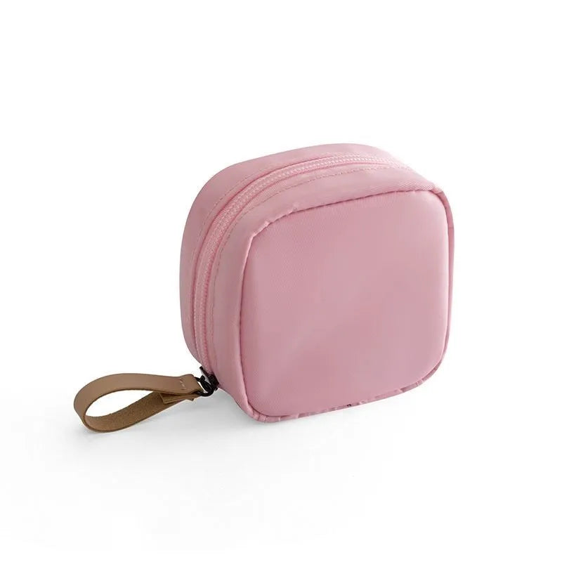 Cloth cube-shaped makeup storage bag in plain pattern available in blue, pink, white, and white pink colours