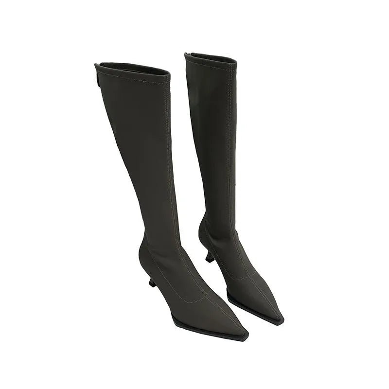 Black pointed toe below the knee women's boots with a stiletto heel and back zipper closure on a white background.
