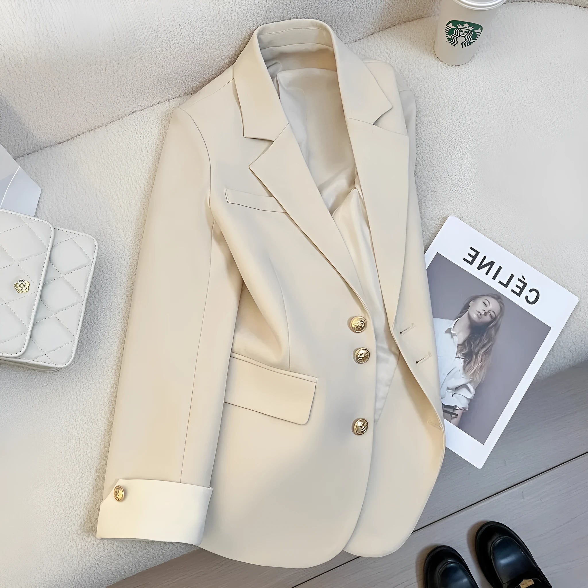 Milky white loose-fit women's trench coat with long sleeves and pockets on a hanger.