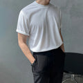 Men's slim fit cotton t-shirt in black, showing round neck and half-sleeve design.