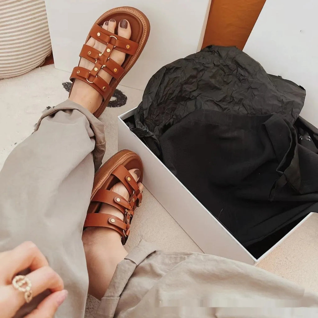 Women's black Roman-style sandal slippers made of glossy patent leather and soft sheepskin.