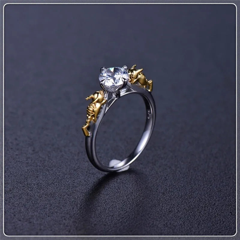 Copper crown cosplay ring with black gold finish and crystal details on a hand.