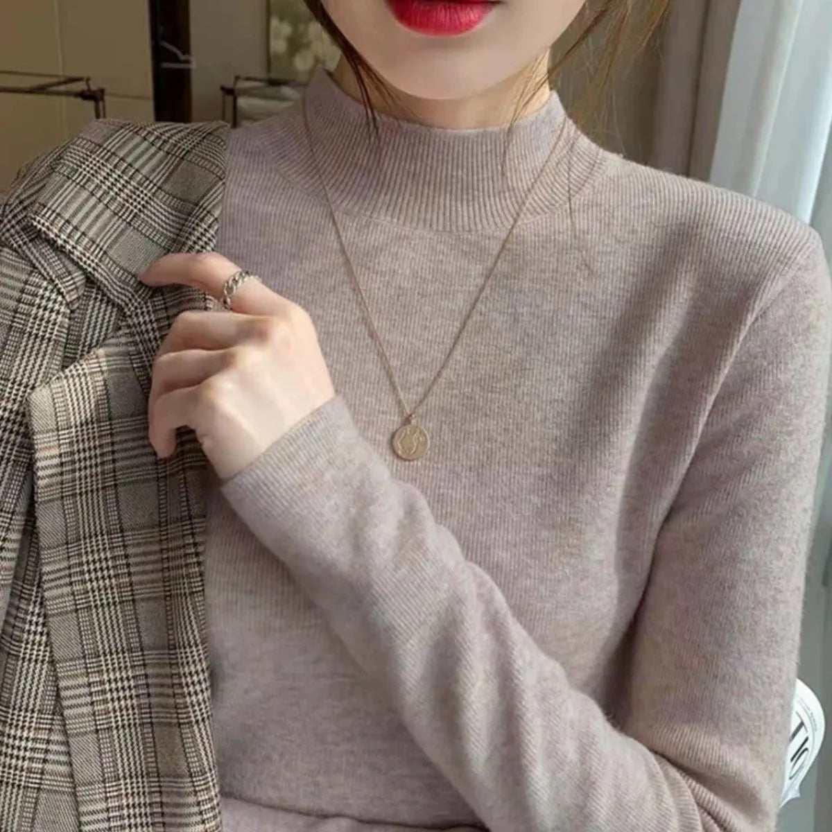 Slim fit knitted viscose bottoming shirt in a neutral colour with long sleeves, shown on a hanger.