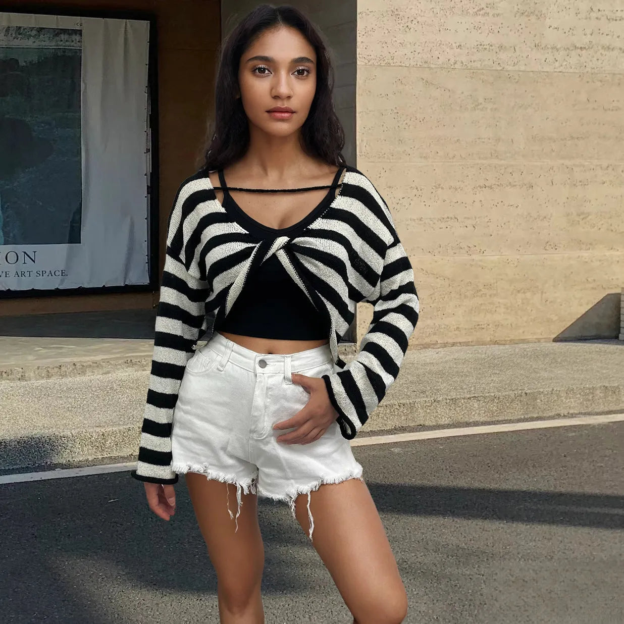 Striped long-sleeved sweater showing front and back wearable design with exposed navel detail