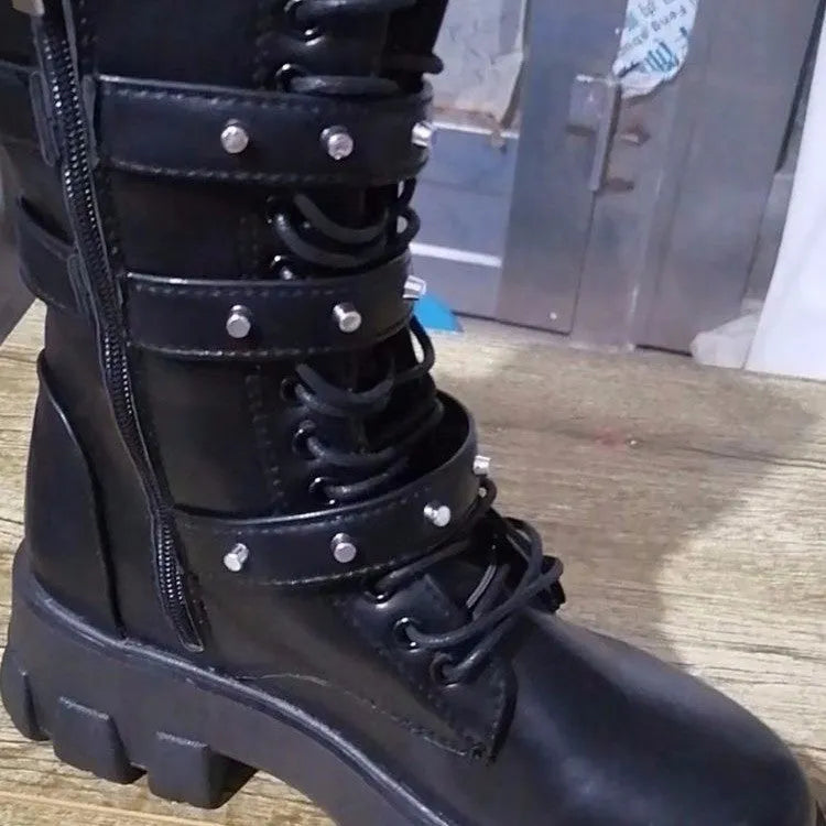 Women's black mid-calf boots with metal buckle straps and a side zipper on a white background.