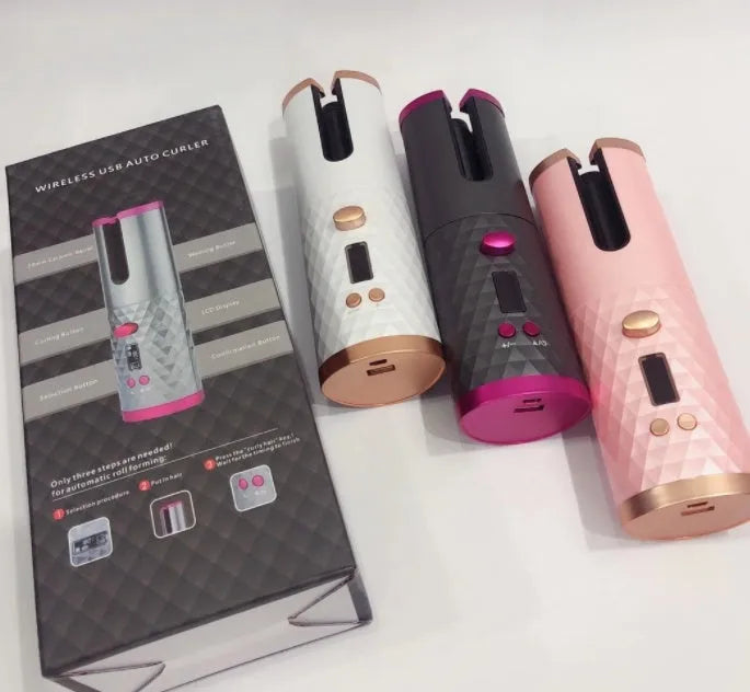 White portable mini curling iron with USB charging cable and gold ceramic barrel on a table.