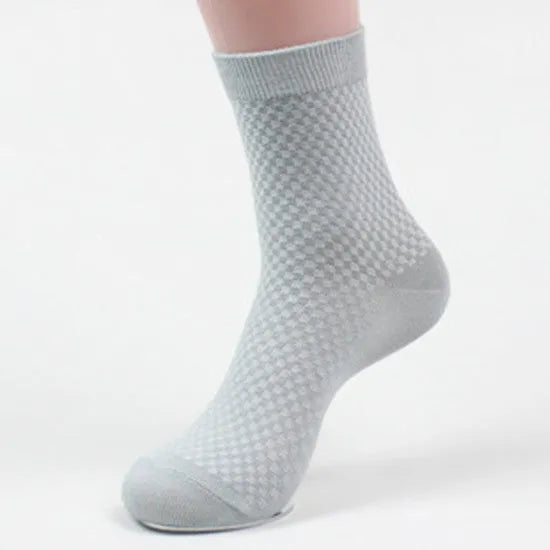 Men's bamboo fibre business socks in small square pattern, shown in classic colours on a grey background.