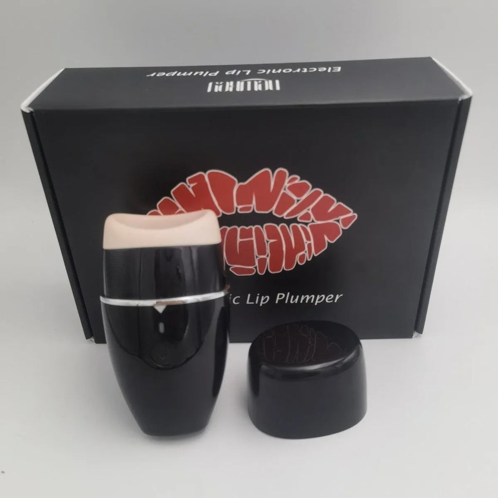 Black and white electric lip plumper device with silicone tip and USB cable on a plain background.
