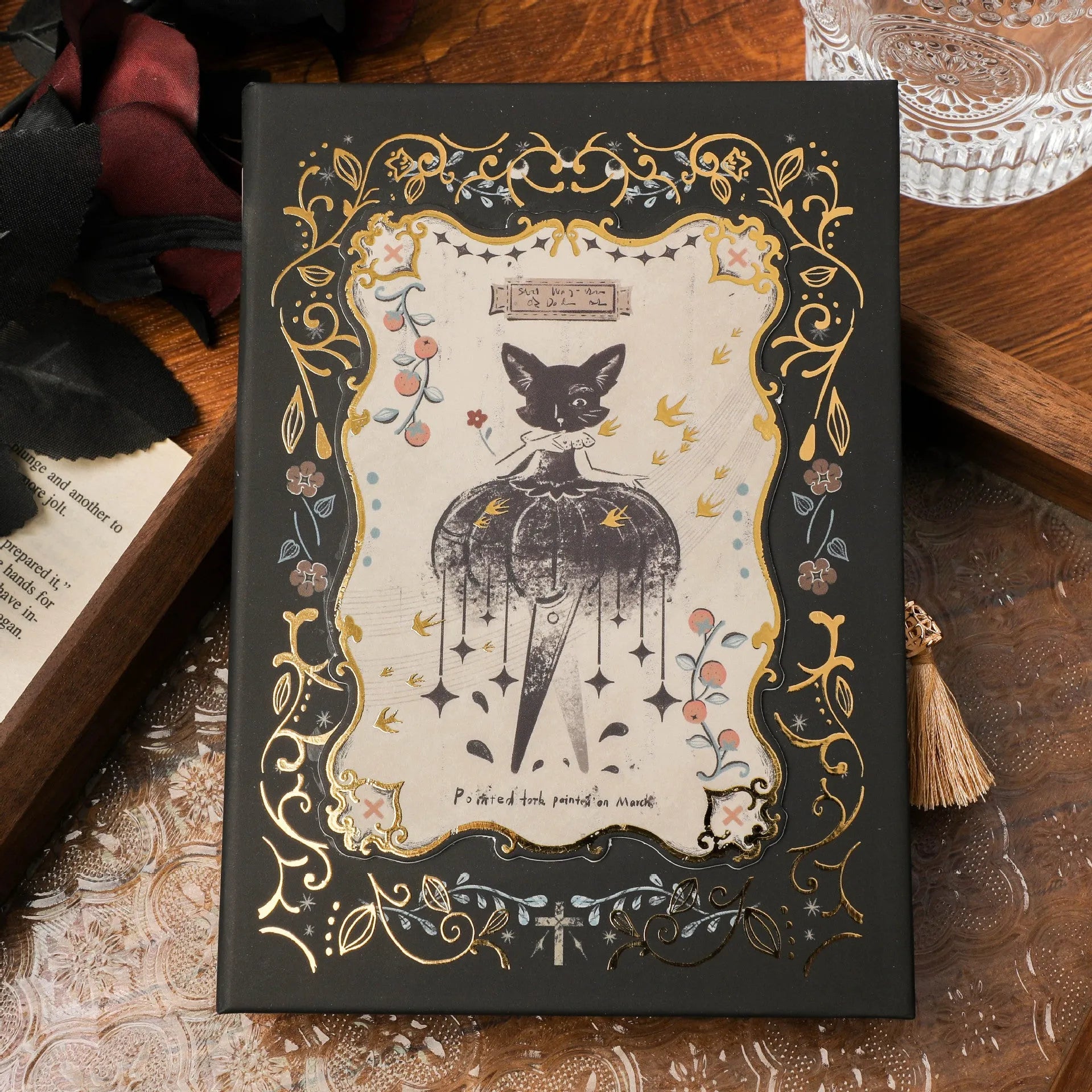 A5 retro Gothic art notebook with thematic cover, shown next to pen for scale
