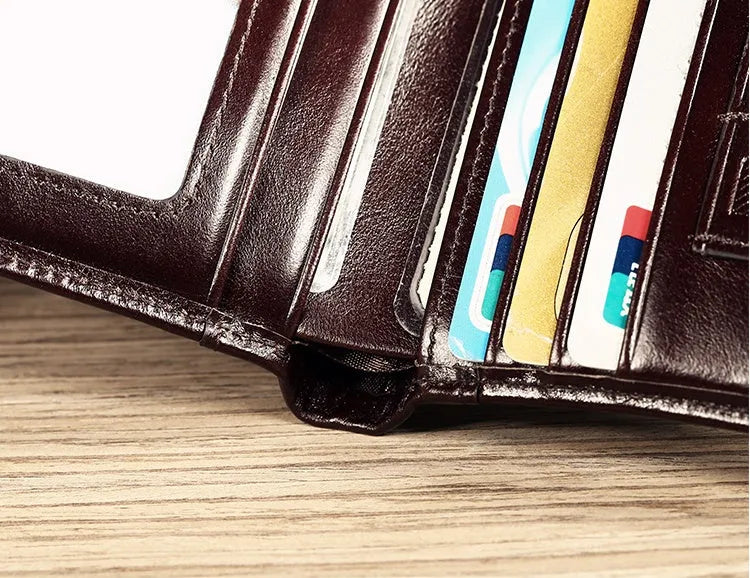 Men's black leather wallet open showing internal card slots, note compartment, and change section.