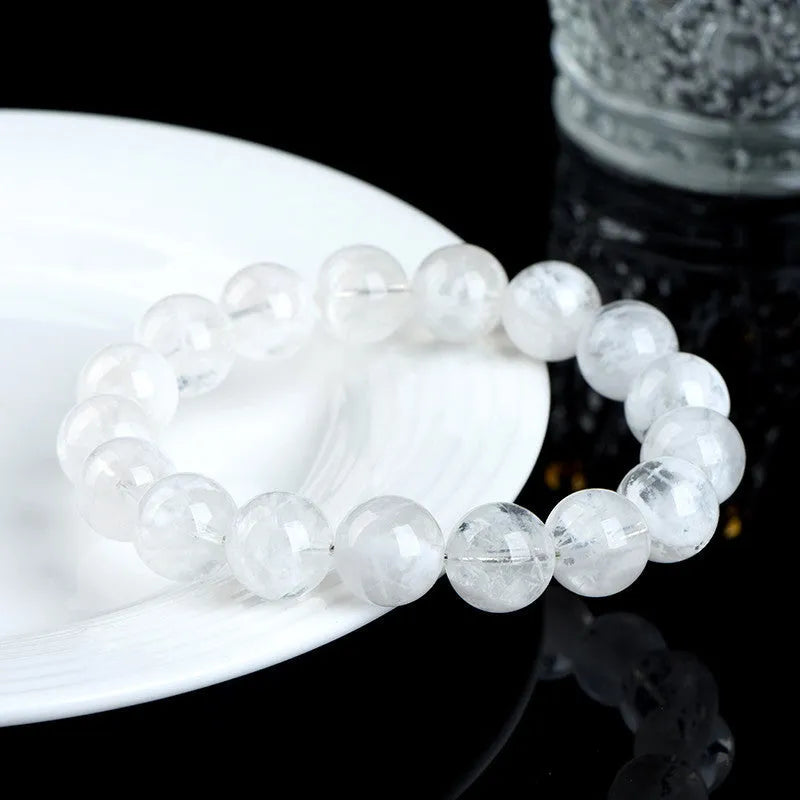 Natural blizzard snowflake crystal bracelet with round beads showing Ruyi and Xiangyun design elements
