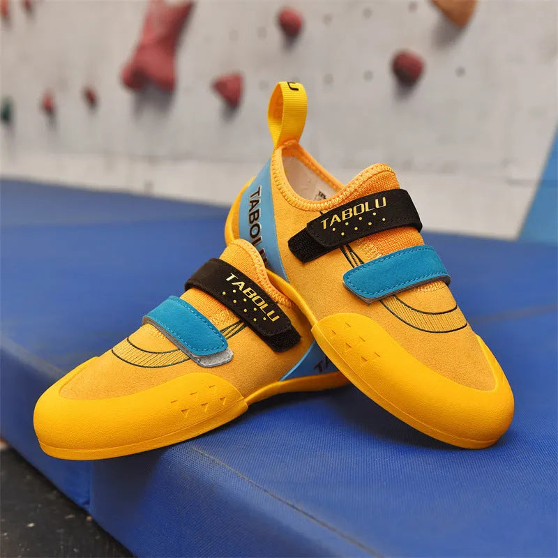 Beginner rock climbing shoes with Velcro strap and wear-resistant rubber sole in black and red colour.