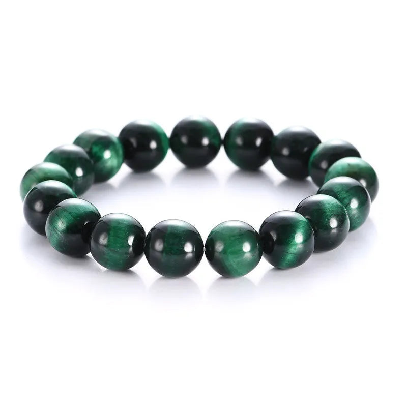 Green tiger eye stone bracelet with geometric beads in various sizes on wrist