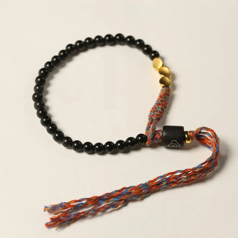Hand-woven obsidian bead bracelet strap on a wrist, showing its 4mm width and dark colour.