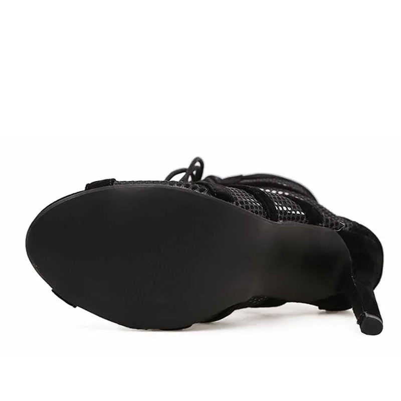 Black suede women's lace-up high heel shoe with ankle strap and 11.5cm heel.