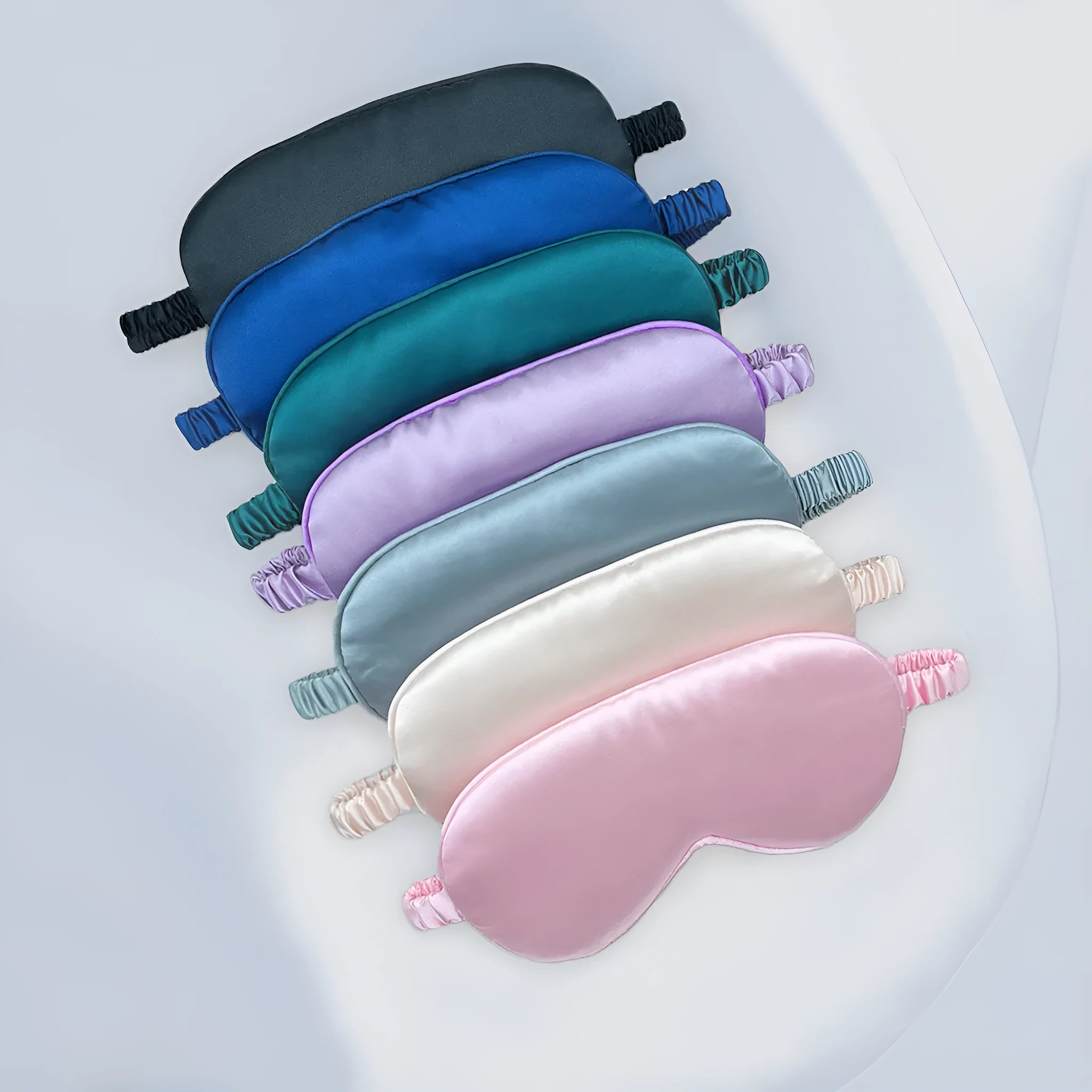 Double-sided rayon elastic satin sleep eyeshade mask in a selection of colours on a white background.