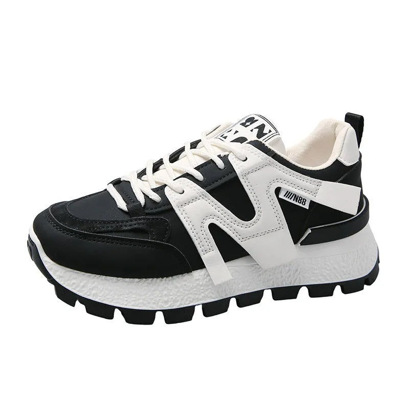 A pair of solid-colour low-top sneakers with a round toe and front lace-up, shown in white or black.