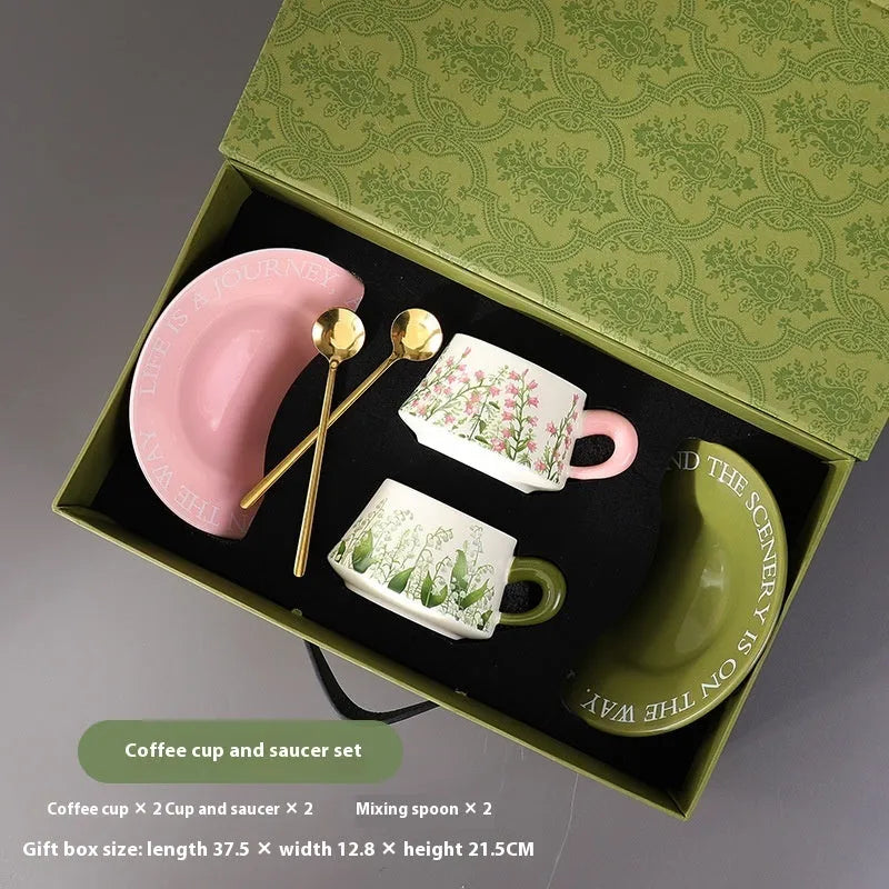Ceramic coffee cup and saucer set for couples with stirring spoons in two pattern choices.