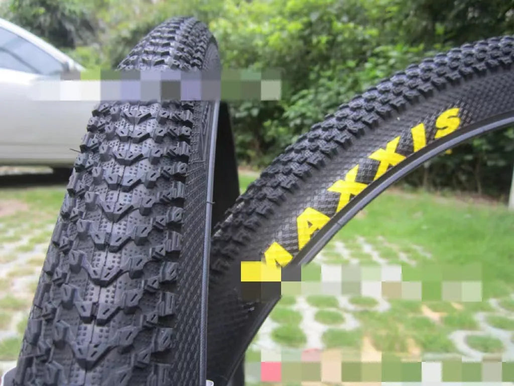 Ultralight puncture-proof mountain bike tyre shown in multiple sizes including 26, 27.5 and 29-inch options.