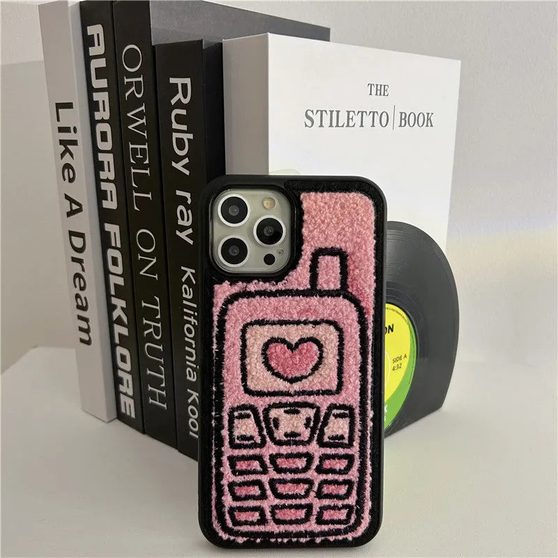 Pink TPU iPhone case with a textured towel-embroidered back cover, shown fitting an iPhone.