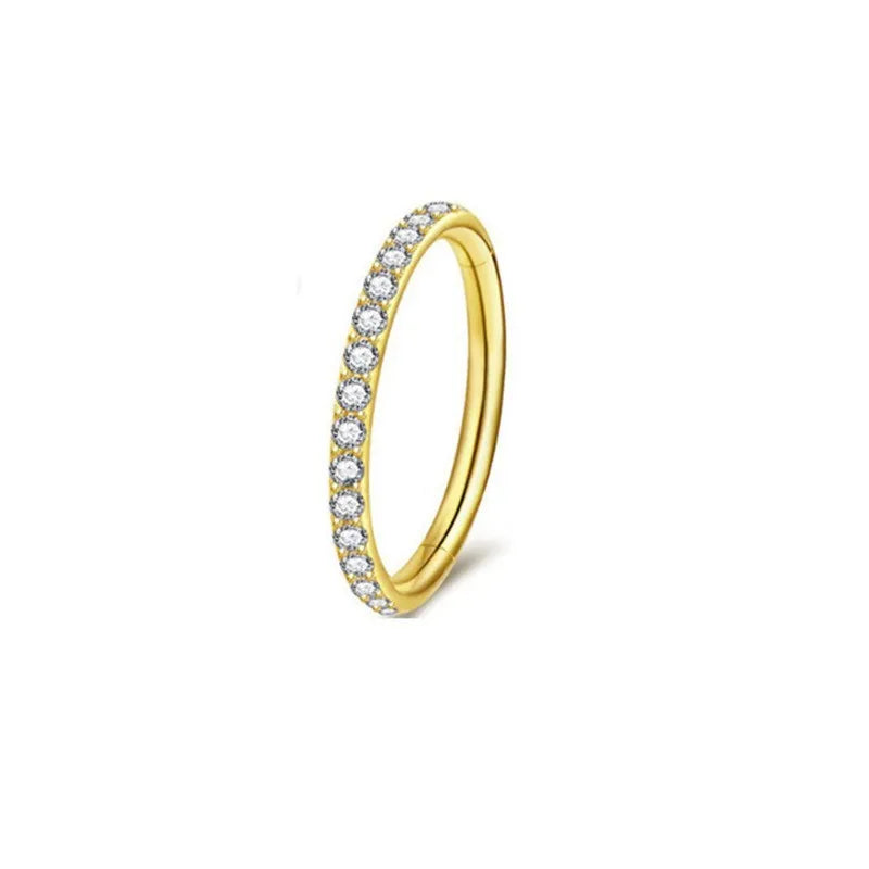 Close-up of a seamless round stainless steel nose ring with a diamond finish, showing colour options including gold, rose gold, and black.