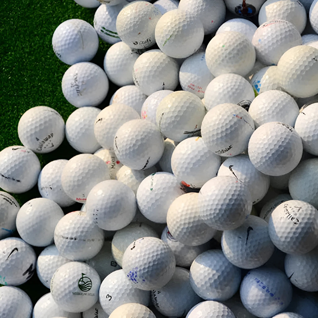 White Golf Next practice game ball with 352 beehive dimples on grass