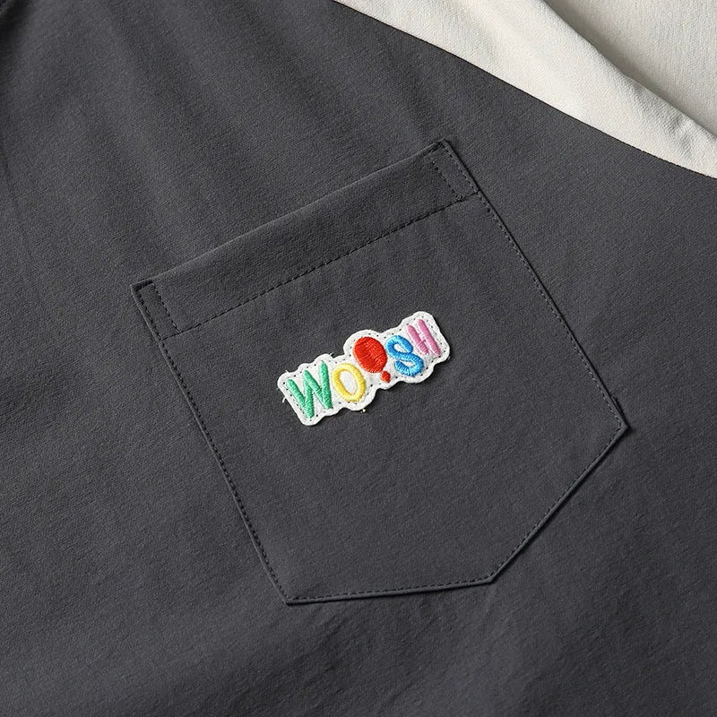 Dark grey men's loose fit t-shirt with contrast raglan sleeves on a neutral background