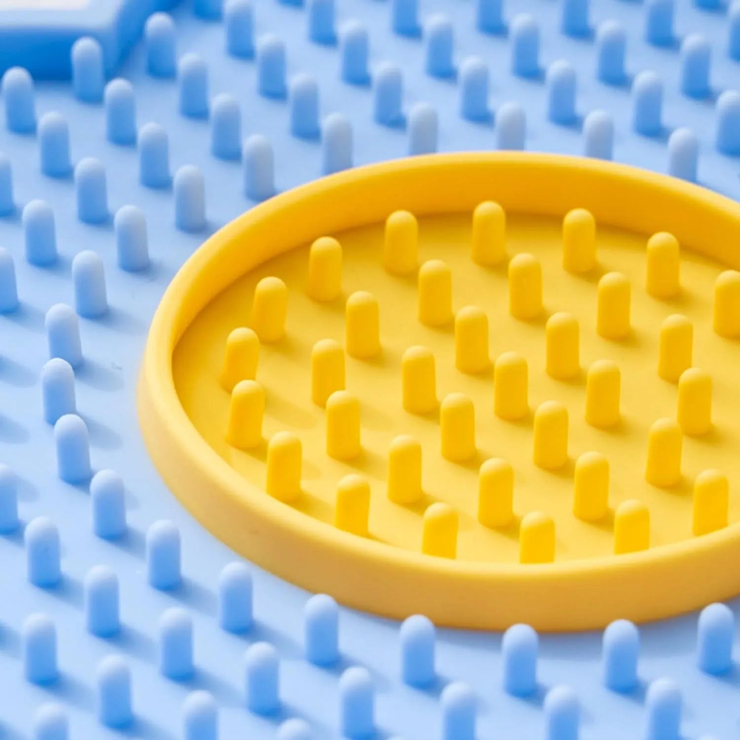 Flower-shaped silicone pet lick pad with suction cup base in assorted colours.