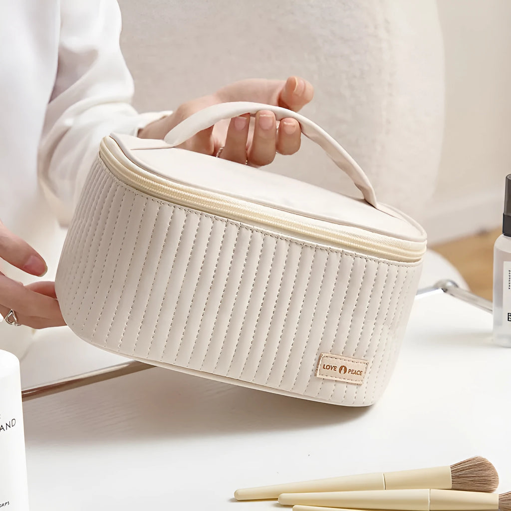 Open-top pink cake-style makeup bag made from PU leather on a table.